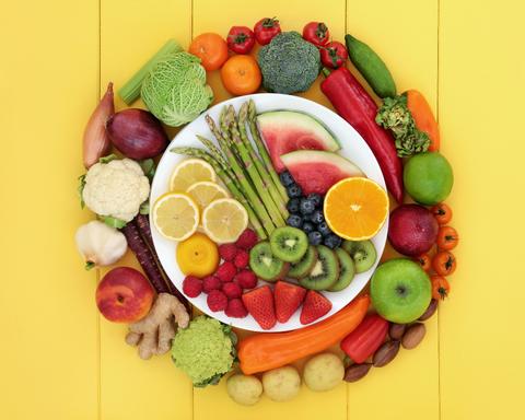 dish with vegetables and fruits with yellow background